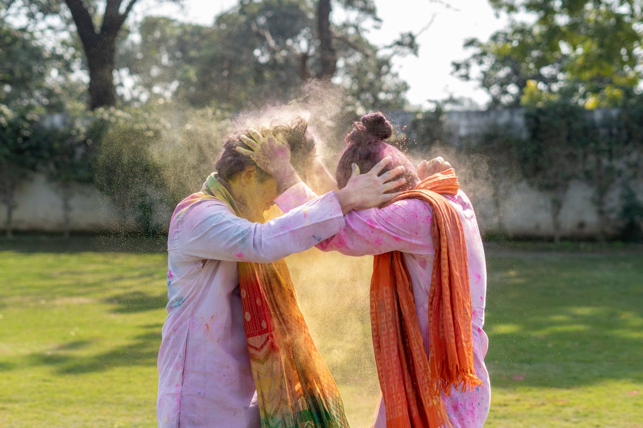 Men in White Long Sleeves Stained with Colorful Powders